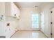 Large laundry room with overhead cabinets and a window at 260 Emerald Lake Dr, Fayetteville, GA 30215