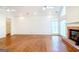 Large living room with hardwood floors, a fireplace, and bright windows at 260 Emerald Lake Dr, Fayetteville, GA 30215