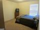 Comfortable bedroom with a simple bed and dresser near the window at 6974 Chilkat Sw Ct, South Fulton, GA 30331