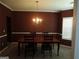 Formal dining room featuring neutral carpet, crown molding, and a hanging chandelier at 6974 Chilkat Sw Ct, South Fulton, GA 30331