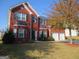 Beautiful two-story brick home featuring a manicured lawn and attached two-car garage at 6974 Chilkat Sw Ct, South Fulton, GA 30331