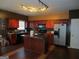 Well-equipped kitchen with red cabinets, modern appliances, and an island at 6974 Chilkat Sw Ct, South Fulton, GA 30331
