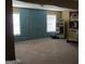 Spacious living area with two windows and neutral carpeting at 6974 Chilkat Sw Ct, South Fulton, GA 30331