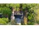 An aerial view of the home's roof surrounded by mature trees offering lots of shade at 2228 Emory Sw St, Covington, GA 30014