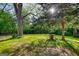 Lush backyard with mature trees, offering ample shade and a serene outdoor space at 2228 Emory Sw St, Covington, GA 30014