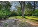 Spacious backyard featuring mature trees and open grassy areas perfect for outdoor activities at 2228 Emory Sw St, Covington, GA 30014