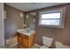 Bathroom with sink, toilet, mirror and window at 2228 Emory Sw St, Covington, GA 30014