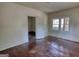 A light-filled bedroom features wood flooring, neutral walls, and an open doorway at 2228 Emory Sw St, Covington, GA 30014