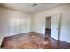 Unfurnished bedroom boasts wood floors, light walls, and an open door at 2228 Emory Sw St, Covington, GA 30014