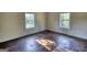 Empty bedroom with wood floors, two windows providing natural light at 2228 Emory Sw St, Covington, GA 30014