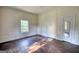 Vacant bedroom features wood flooring, light walls, and a window at 2228 Emory Sw St, Covington, GA 30014