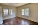 Empty bedroom has wood floors, white trim, and windows with natural light at 2228 Emory Sw St, Covington, GA 30014