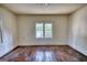 Vacant bedroom with hardwood flooring and a window at 2228 Emory Sw St, Covington, GA 30014