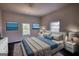 Staged primary bedroom with matching furniture and bright windows at 2228 Emory Sw St, Covington, GA 30014
