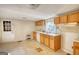 Kitchen with wood cabinets, double sink, dishwasher and natural light at 2228 Emory Sw St, Covington, GA 30014