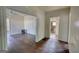 Open concept living room with hardwood floors and view of the bathroom at 2228 Emory Sw St, Covington, GA 30014