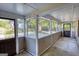 Screened porch with concrete floors, providing an airy outdoor living space with views of the surrounding neighborhood at 2228 Emory Sw St, Covington, GA 30014