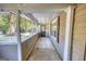 Enclosed porch with concrete floors, providing an airy outdoor space with views of the front yard at 2228 Emory Sw St, Covington, GA 30014