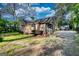 Rear exterior view of a cottage with a spacious yard, showcasing its serene and private setting at 2228 Emory Sw St, Covington, GA 30014