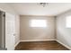 Bedroom with hardwood floors, a window with blinds, and a white door at 322 E Rhinehill Rd, Atlanta, GA 30315