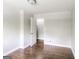 Bedroom features hardwood floors, a window, and a white door at 322 E Rhinehill Rd, Atlanta, GA 30315
