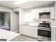 Modern kitchen boasts updated appliances, white cabinets, and sleek countertops at 322 E Rhinehill Rd, Atlanta, GA 30315