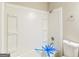 Bathroom featuring white bathtub with shower and storage space at 5998 Radford Dr, Riverdale, GA 30296