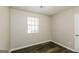 This bedroom features durable flooring, neutral walls, and a window with natural light at 5998 Radford Dr, Riverdale, GA 30296