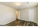 Bedroom featuring durable flooring, neutral walls, white doors, and overhead lighting at 5998 Radford Dr, Riverdale, GA 30296