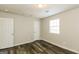 This bedroom features durable flooring, neutral walls, white doors, and a window at 5998 Radford Dr, Riverdale, GA 30296