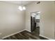 Dining room with modern chandelier, wood floors, leading into the kitchen with stainless steel appliances at 5998 Radford Dr, Riverdale, GA 30296