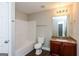 Bathroom with a shower/tub combo, granite vanity, and hardwood style flooring at 7481 Absinth Dr, Atlanta, GA 30349