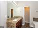 Bathroom features a double sink vanity with granite countertop and wood cabinets at 7481 Absinth Dr, Atlanta, GA 30349