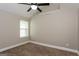 Bedroom features a ceiling fan, a window with blinds, and neutral decor at 7481 Absinth Dr, Atlanta, GA 30349