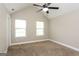 Bedroom with ceiling fan, two windows providing natural light, and carpeted flooring at 7481 Absinth Dr, Atlanta, GA 30349