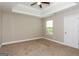 Bedroom featuring tray ceilings, a ceiling fan, and large window providing natural light at 7481 Absinth Dr, Atlanta, GA 30349