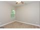 Cozy bedroom with a large window and neutral carpet, perfect for relaxation at 7481 Absinth Dr, Atlanta, GA 30349