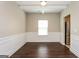 Formal dining room featuring stylish molding, hardwood floors, and a modern light fixture at 7481 Absinth Dr, Atlanta, GA 30349