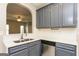 Well-equipped kitchen with stainless steel appliances, gray cabinets, and bright countertops at 7481 Absinth Dr, Atlanta, GA 30349
