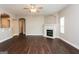 Spacious living room featuring an elegant fireplace, modern ceiling fan, and hardwood floors at 7481 Absinth Dr, Atlanta, GA 30349