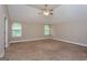 Expansive main bedroom featuring a ceiling fan and neutral carpeting at 7481 Absinth Dr, Atlanta, GA 30349