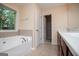 Bright bathroom with a large soaking tub and a view from the window at 1015 Buckeye Ln, Villa Rica, GA 30180