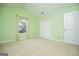 Spacious bedroom with neutral carpet, a double closet, and a large window at 1015 Buckeye Ln, Villa Rica, GA 30180