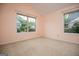 Bedroom featuring neutral carpet, baseboards, paint, and two windows at 1015 Buckeye Ln, Villa Rica, GA 30180