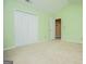 Green-painted bedroom featuring neutral carpet and a double closet at 1015 Buckeye Ln, Villa Rica, GA 30180