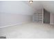 Large bonus room featuring neutral carpet, vaulted ceilings and shelving unit at 1015 Buckeye Ln, Villa Rica, GA 30180
