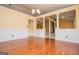 Open-concept dining room with hardwood floors, wainscoting, decorative columns, and views of the fireplace at 1015 Buckeye Ln, Villa Rica, GA 30180