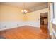 Bright dining room featuring hardwood floors, wainscoting, and views of the kitchen area at 1015 Buckeye Ln, Villa Rica, GA 30180