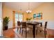 Bright dining room with hardwood floors, wainscoting, modern chandelier, table setting, and large window at 1015 Buckeye Ln, Villa Rica, GA 30180