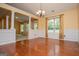 Formal dining room featuring hardwood floors, wainscoting, large windows, and decorative columns at 1015 Buckeye Ln, Villa Rica, GA 30180